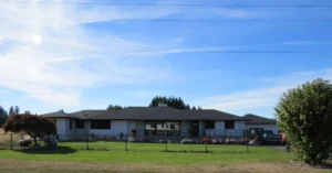 Front of Christina's Place, a single-story home on a wide green lawn