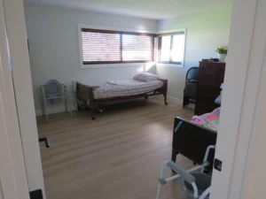 Resident bedroom with a care bed and natural light