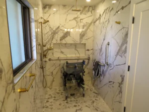 Accessible walk-in shower with grab bars and a shower chair