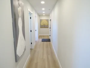 Wide hallway with light wood floors